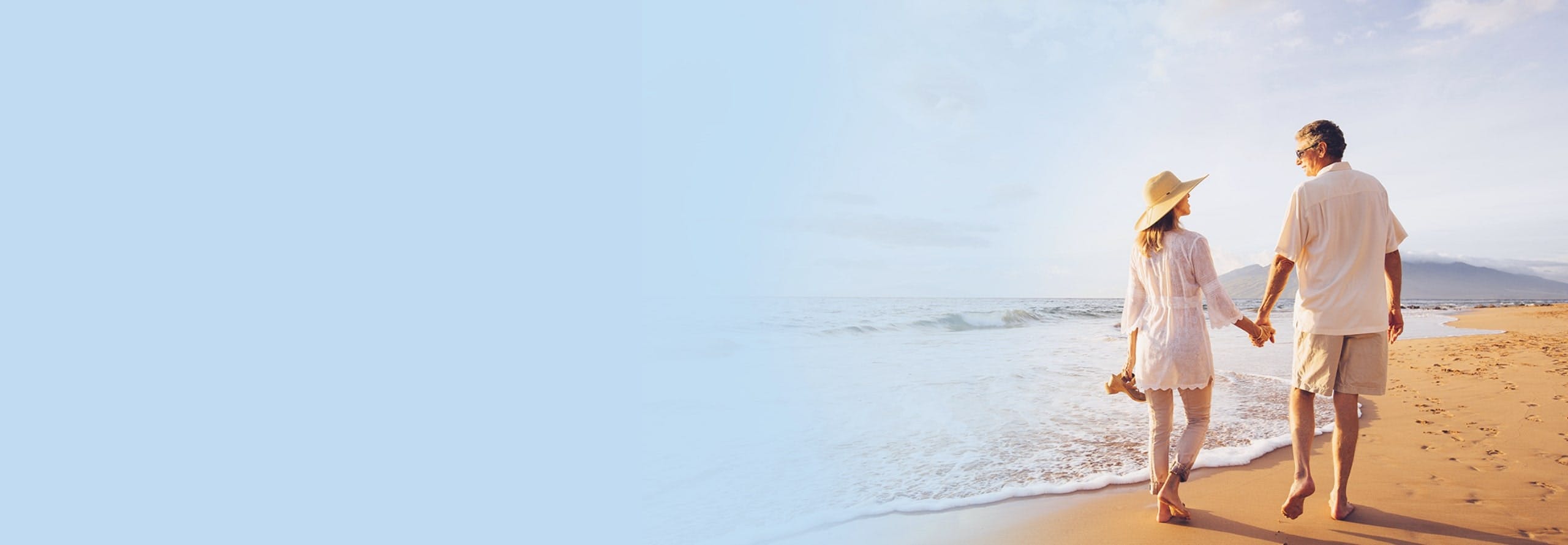 Retired couple walking by the beach